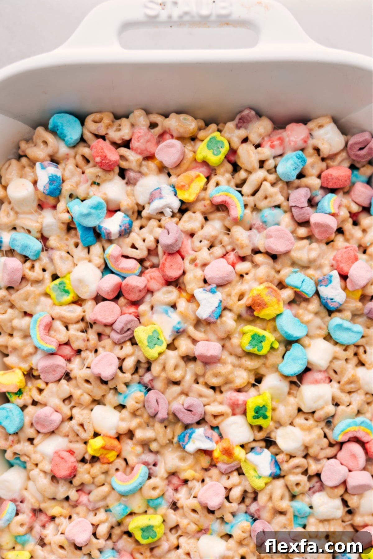 A pan full of vibrant Lucky Charms Bars, perfectly set and ready to be cut into squares and served for any occasion, especially St. Patrick's Day.