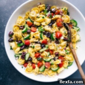 Greek tortellini salad in a serving bowl, perfectly dressed and ready to be enjoyed.