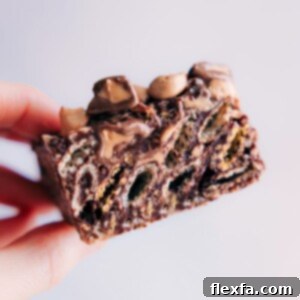 Finished Muddy Buddy Bars cut into squares and dusted with powdered sugar