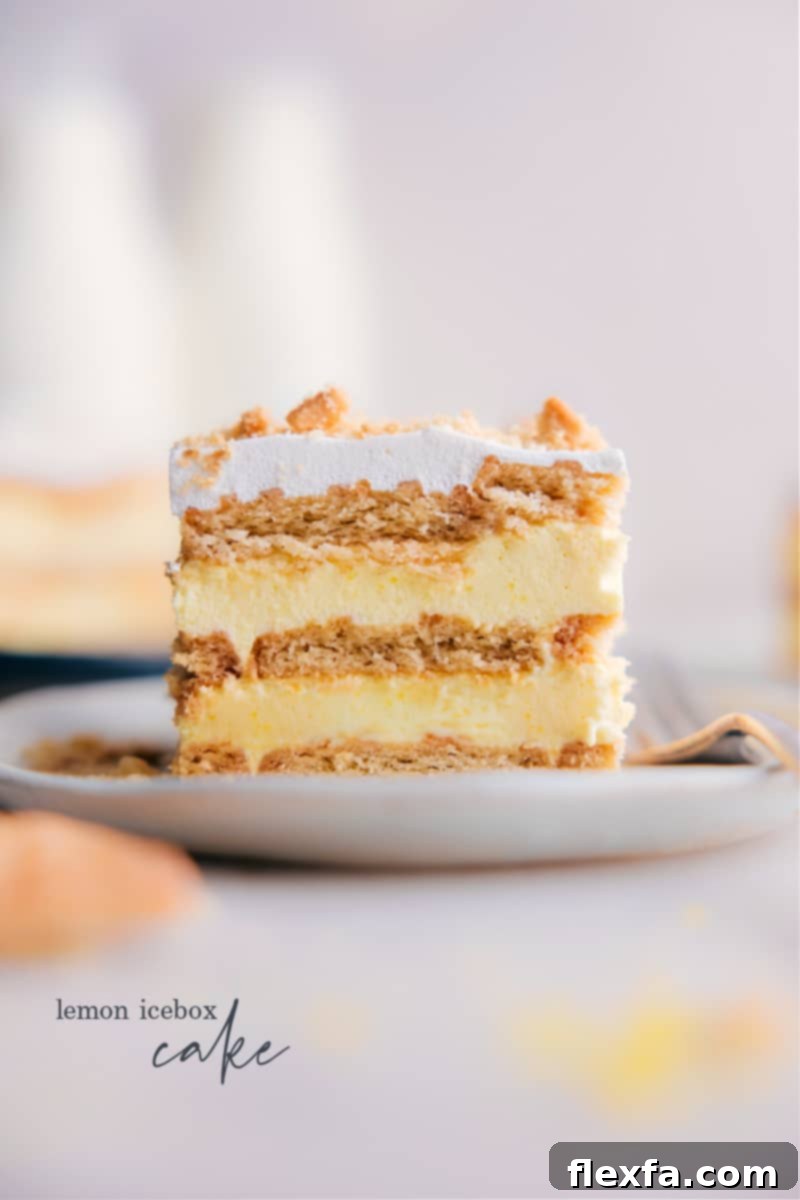 A vibrant slice of Lemon Icebox Cake, showcasing its creamy lemon pudding layers, soft shortbread cookies, and a hint of fresh lemon zest on top.
