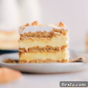 A beautifully presented slice of Lemon Icebox Cake, featuring creamy yellow layers and a cookie base.