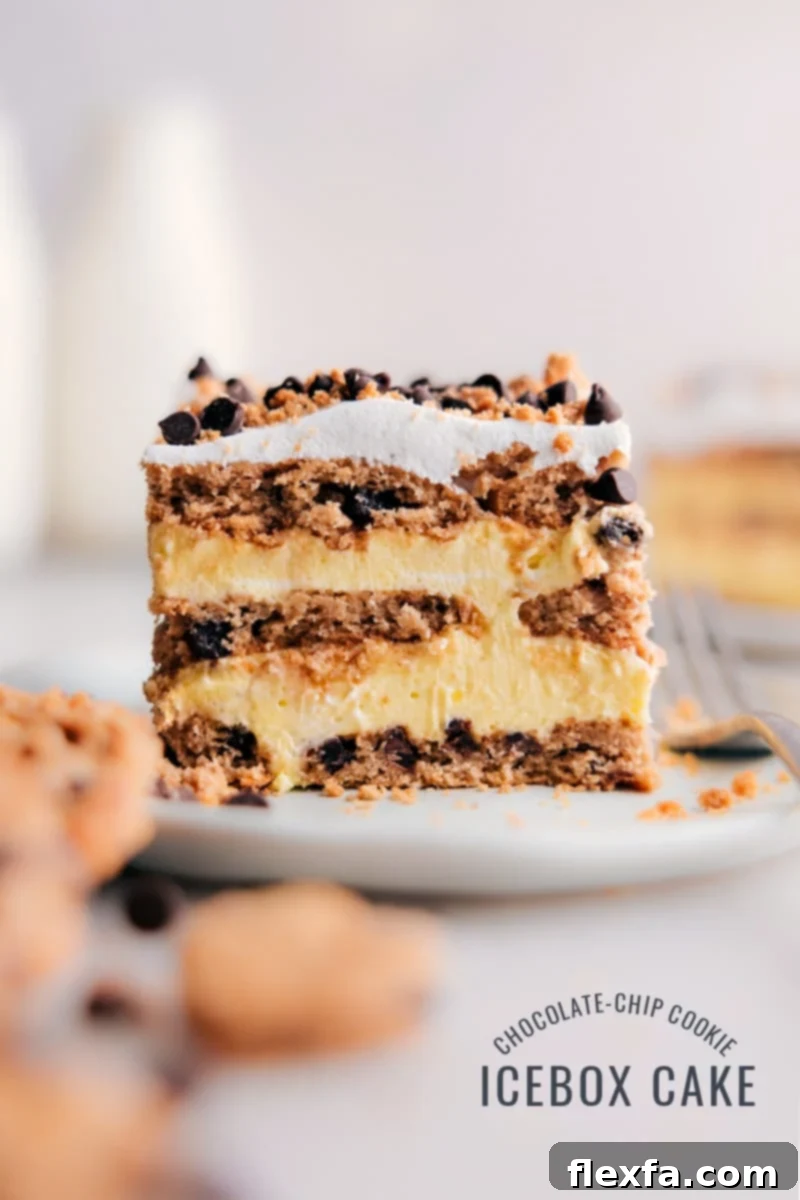A perfectly sliced piece of Chocolate Chip Cookie Icebox Cake on a white plate, showcasing its beautiful layers of creamy filling and softened chocolate chip cookies. A fork has taken a bite, revealing the luscious texture.