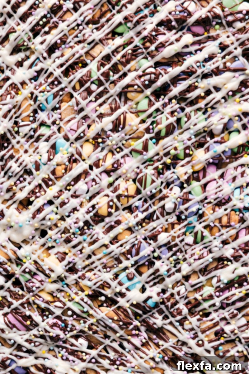 Finished Easter Snack Mix with bunny grahams and pastel M&M's. A close-up overhead shot of the finished Easter Snack Mix, showcasing the textures and colorful sprinkles.