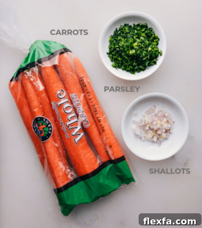Ingredient shot-- image of all the ingredients used in this French Carrot Salad recipe, including carrots, shallots, parsley, lemon, olive oil, Dijon mustard, and honey