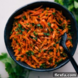 A refreshing French Carrot Salad featuring freshly grated carrots, diced shallots, and chopped parsley