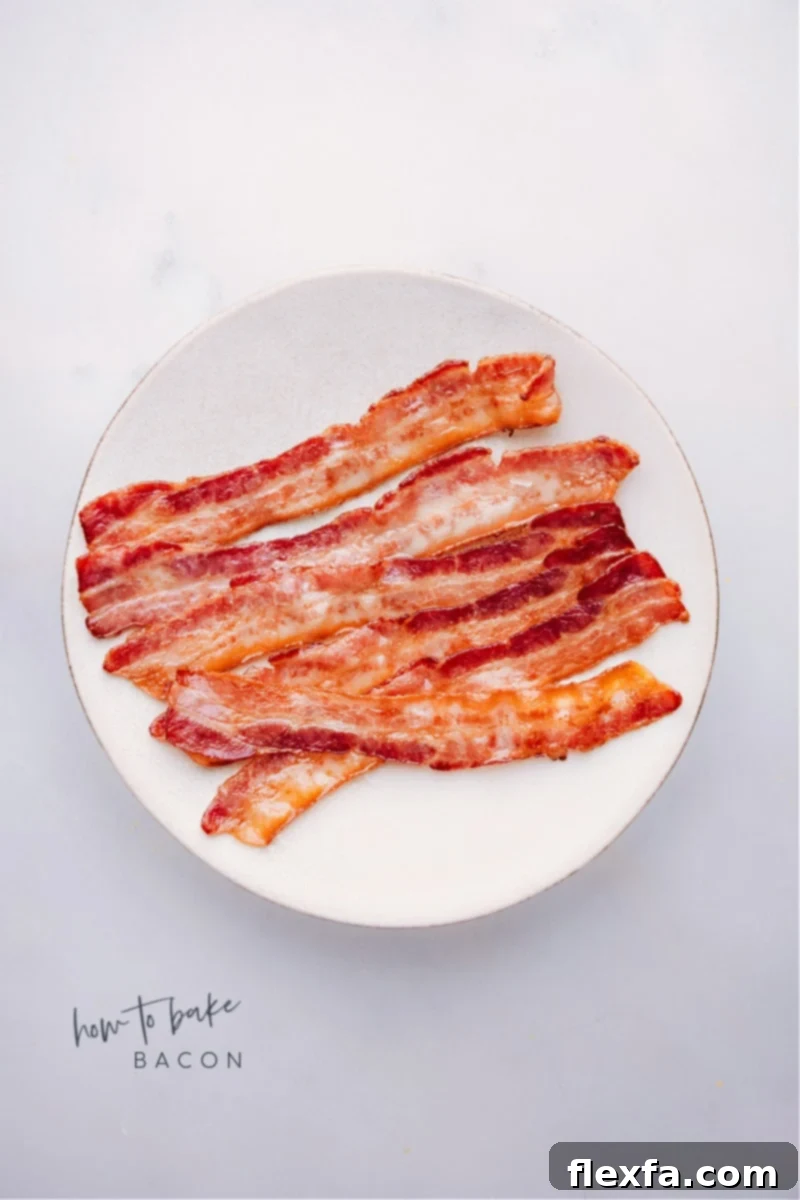 Overhead image of beautifully baked crispy bacon strips on a cooling rack over a sheet pan, ready to be served