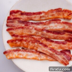 Baked bacon strips, perfectly cooked and crispy, shown in a close-up