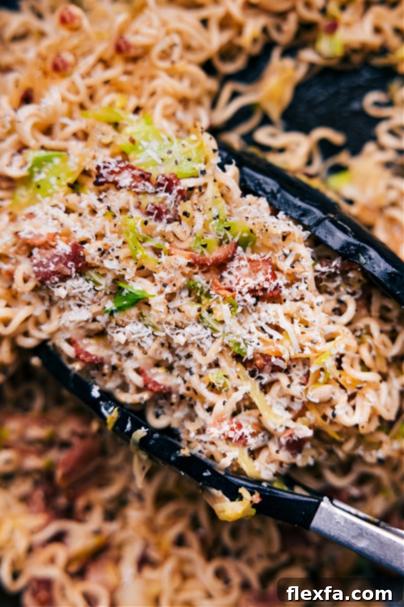 Finished Fried Cabbage Ramen An inviting, up-close overhead image of the finished Fried Cabbage Ramen in a bowl, steam subtly rising, ready to be devoured and highlighting the crispy bacon, tender cabbage, and perfectly coated noodles.