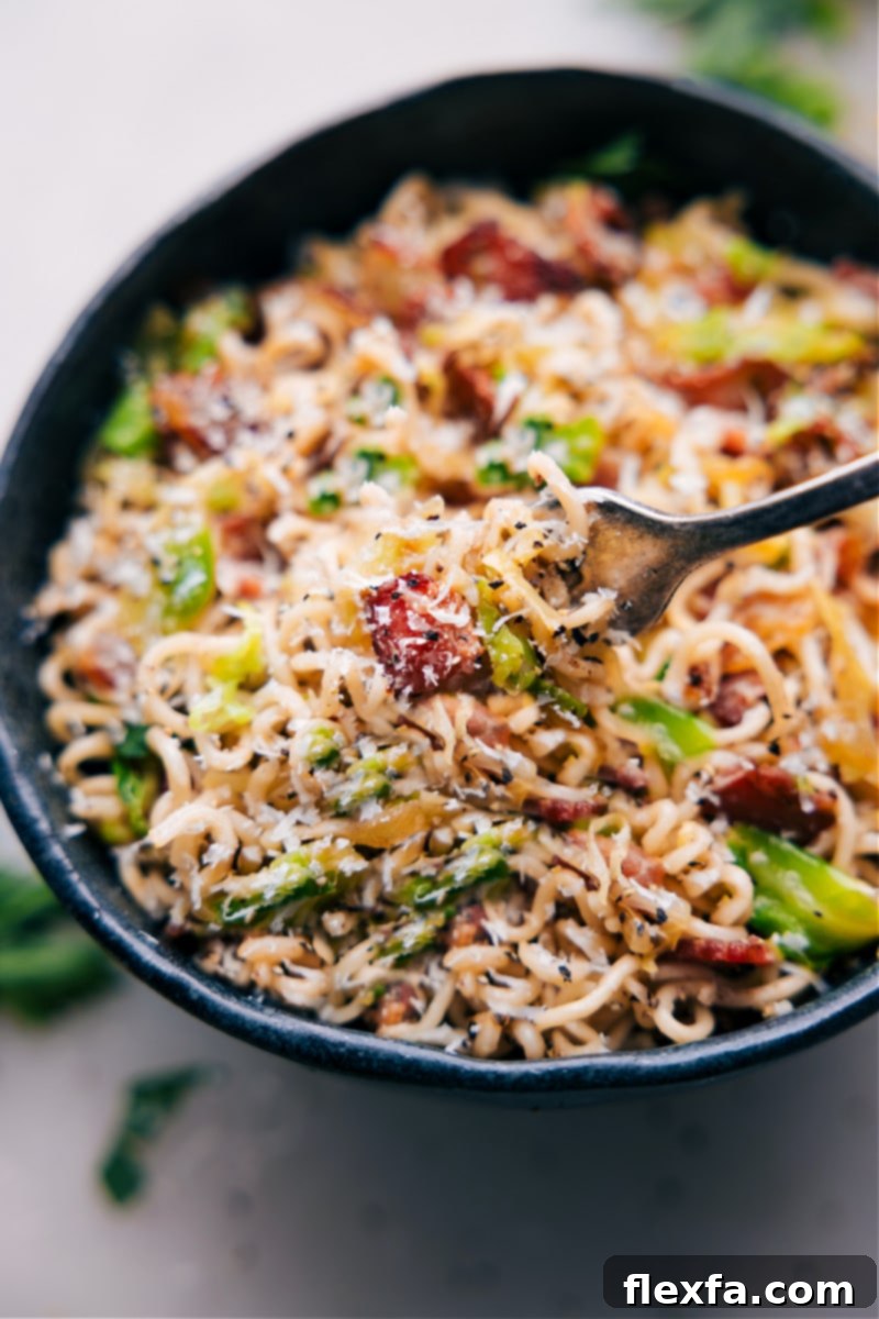 Forkful of Fried Cabbage Ramen A close-up image of a fork lifting a generous portion of Fried Cabbage Ramen from a bowl, highlighting the noodles, bacon, and cabbage, enticing the viewer to taste.