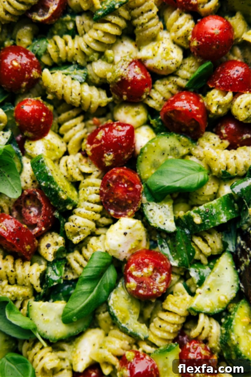Fresh Pesto Pasta Delight 7 Close-up overhead image of a single serving of Pesto Pasta Salad in a smaller decorative bowl, highlighting its vibrant ingredients and appetizing appeal as a perfect side dish.