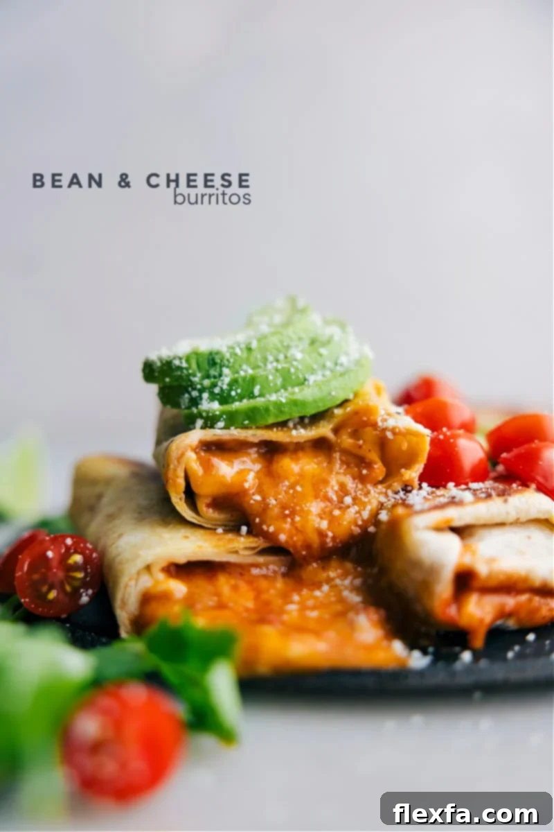 Image of crispy baked Bean and Cheese Burritos with melted cheddar and fresh toppings