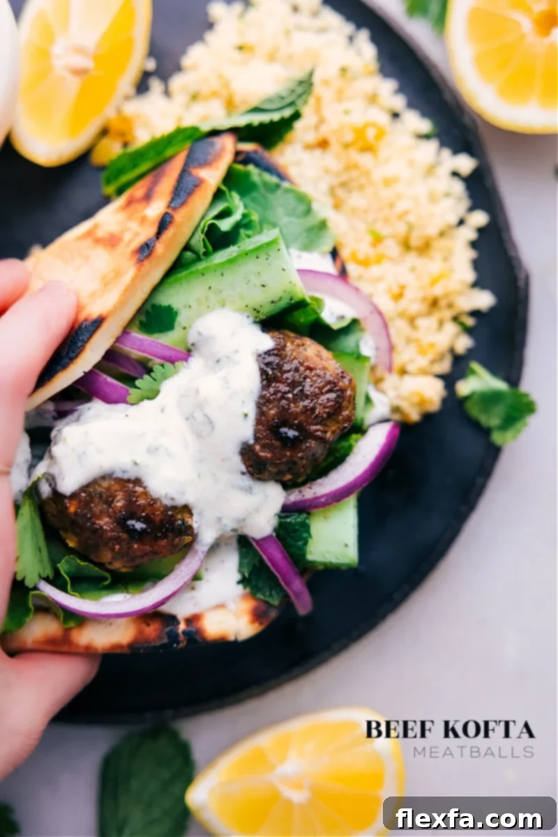 Spiced Beef Kofta 2 Overhead image of freshly prepared Beef Kofta Meatballs served in pita with mint-yogurt sauce and fresh vegetables