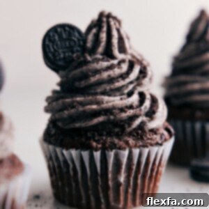 Close-up of fluffy Oreo Frosting in a bowl, with crushed Oreos visible, ready to be spread.