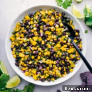 A close-up shot of the finished Mango Black Bean Salsa in a bowl, garnished with fresh cilantro, vibrant and ready to serve.