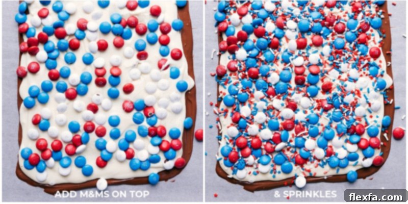 Close-up of patriotic sprinkles and M&Ms being added to the freshly spread white chocolate layer on 4th of July Bark.
