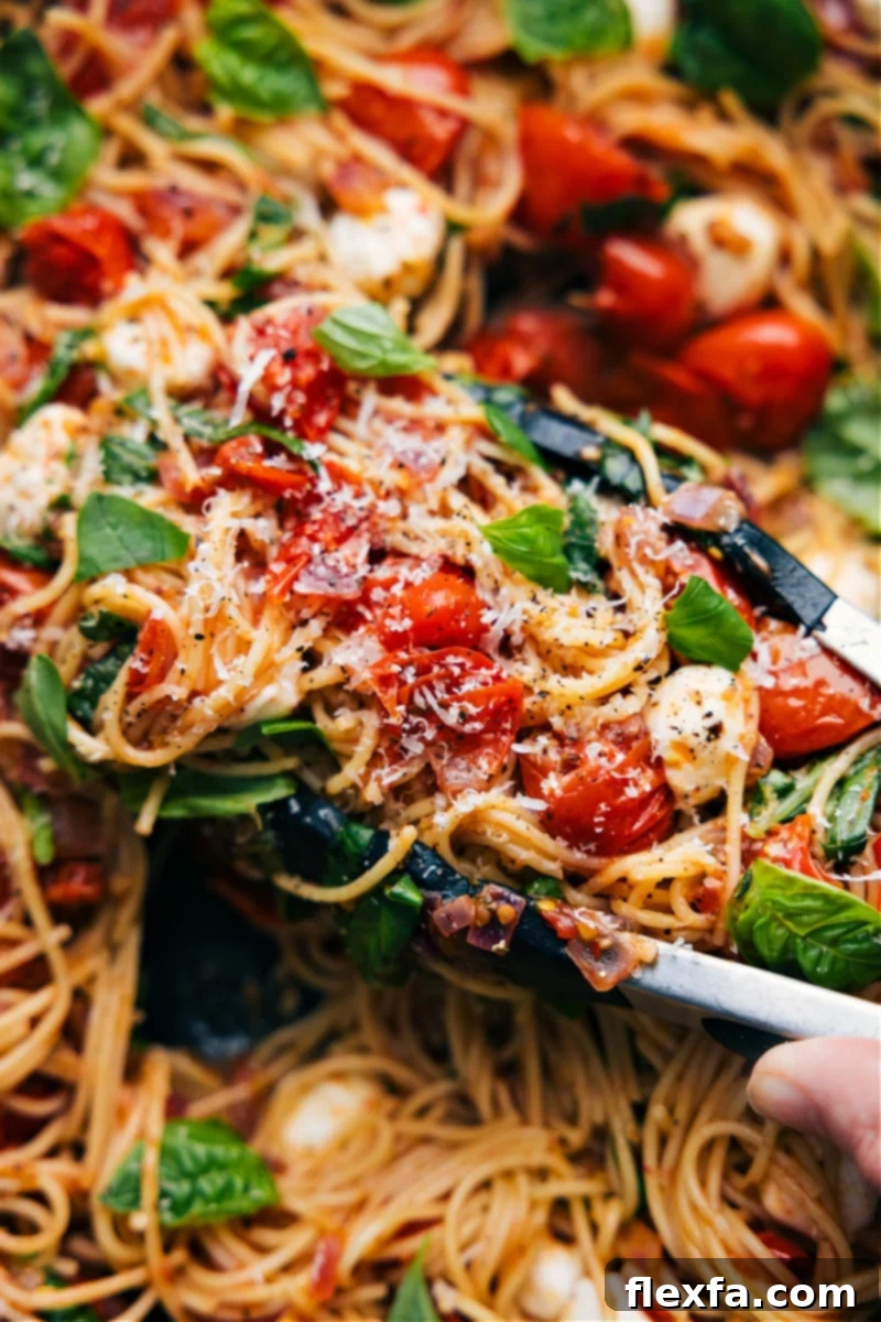 Overhead image of freshly made Caprese Pasta garnished with basil