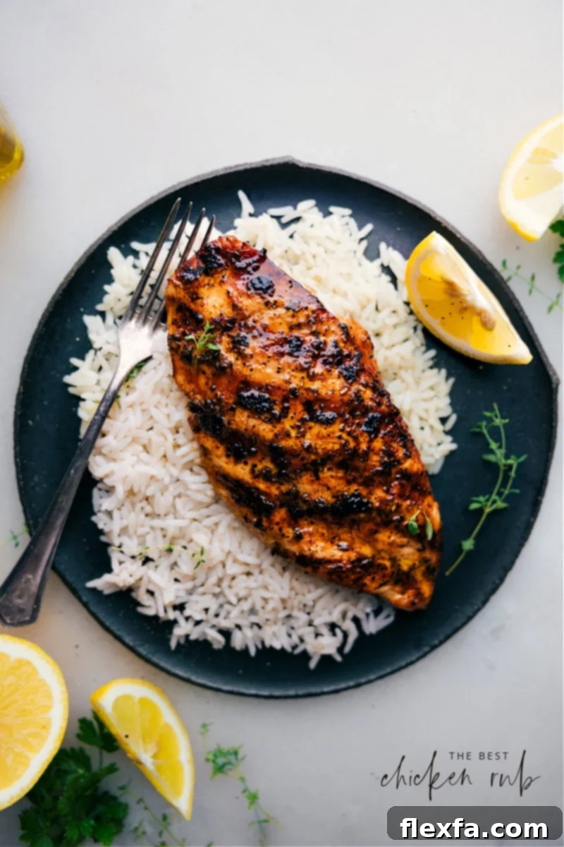 Best chicken rub recipe on a bed of rice, showcasing a perfectly seasoned and cooked chicken.