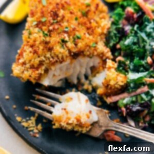 Delicious Baked Cod with a crispy topping and lemon wedges.