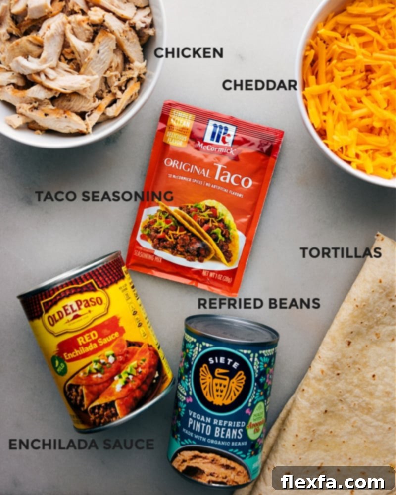 An overhead shot showcasing all the fresh, vibrant ingredients required for preparing Crispy Chicken Wraps, including perfectly shredded chicken, rich cheddar cheese, soft tortillas, creamy refried beans, and essential seasonings, all neatly arranged and ready for preparation.