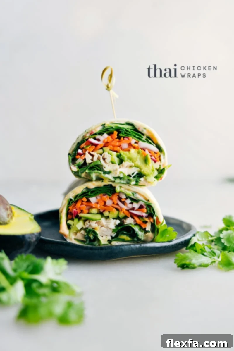 Delicious Thai Chicken Wraps neatly arranged on a plate, garnished with fresh cilantro, ready to be enjoyed.
