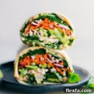 A beautifully assembled Thai Chicken Wrap, cut in half, showing off the colorful filling.