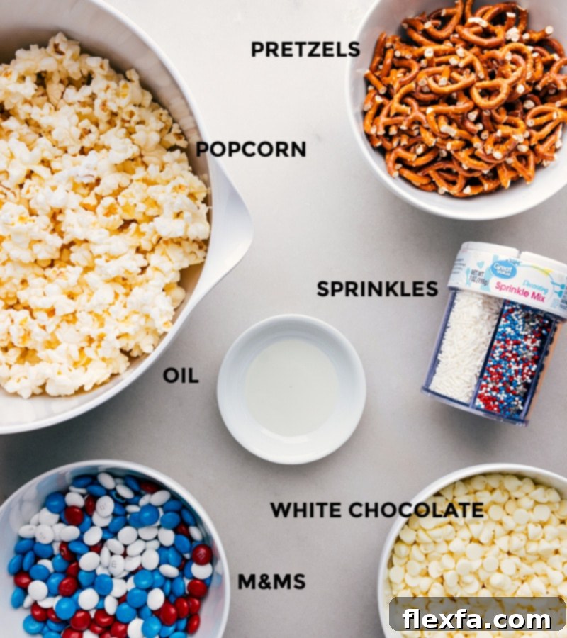 All the vibrant ingredients for a perfect 4th of July Popcorn mix, including fluffy plain popcorn, mini pretzel twists, cheerful red, white, and blue M&M's, quality white chocolate chips, neutral oil, and festive sprinkles, thoughtfully arranged and ready for easy assembly on a light-colored surface.