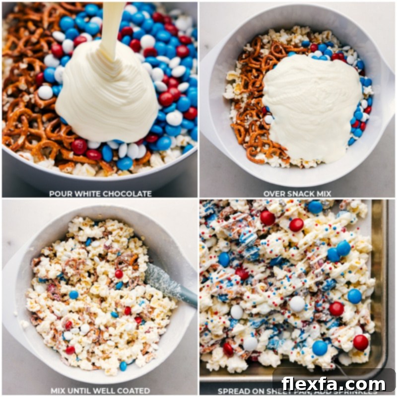 Melted white chocolate being poured into a large bowl filled with popped popcorn, broken pretzels, and red, white, and blue M&M's, with a spatula poised for mixing, illustrating a key step in making 4th of July Popcorn.