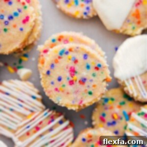 Beautifully arranged slice and bake cookies with sprinkles, some drizzled with white chocolate.
