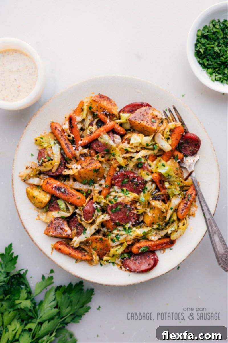 One-Pan Cabbage, Potatoes, and Sausage: Smoky sausage, roasted veggies, Parmesan, and creamy Dijon sauce – a hearty, easy, and flavorful dinner idea. Overhead image of the Cabbage, Potatoes, and Sausage dish, showing smoky sausage and roasted vegetables with creamy Dijonnaise.