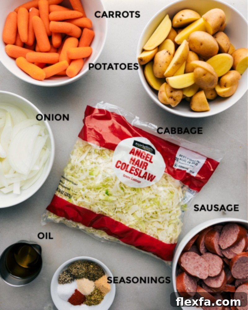 Essential ingredients for our Cabbage, Potatoes, and Sausage: fresh produce and savory sausage for a flavorful, easy sheet pan dinner. Ingredient shot showing all fresh ingredients for Cabbage, Potatoes, and Sausage including baby potatoes, cabbage, carrots, sausage, and spices.