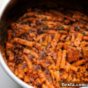Close-up of Instant Pot Baked Ziti garnished with fresh basil