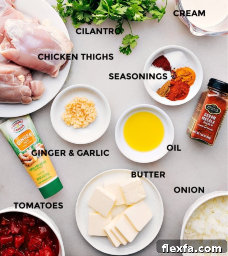 Array of ingredients assembled for the instant pot butter chicken recipe, including spices, chicken, tomatoes, and cream.