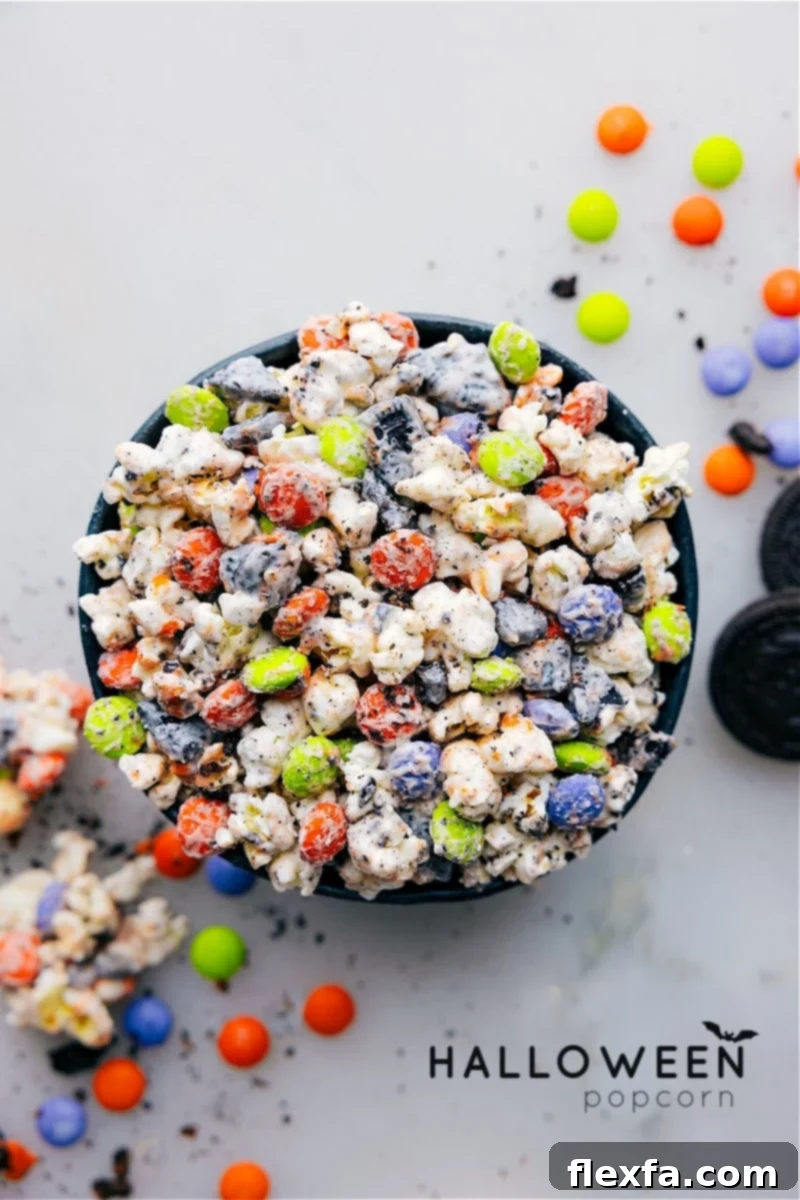 Overhead view of a bowl of Halloween Popcorn with white chocolate, M&Ms, and Oreos