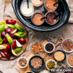 A beautifully arranged Caramel Apple Bar with various dips, toppings, and fresh apple slices.