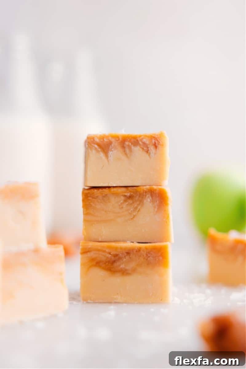 Three pieces of perfectly stacked Caramel Apple Fudge, showing the distinct layers and inviting texture.
