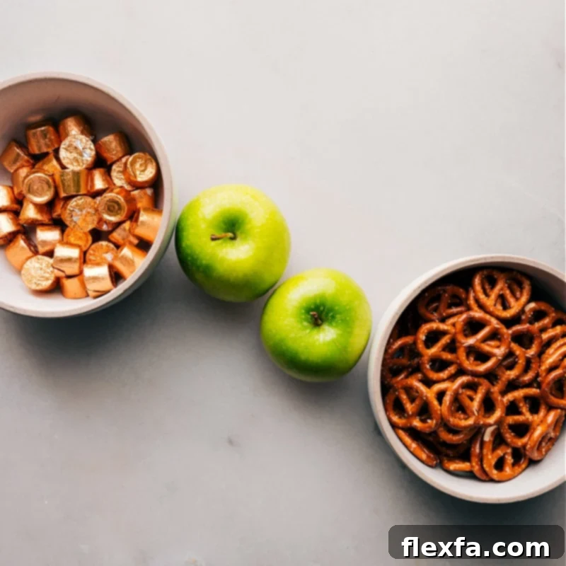 The three core ingredients – pretzels, Granny Smith apple, and Rolos – neatly laid out for simple recipe assembly, showcasing their readiness to be combined.