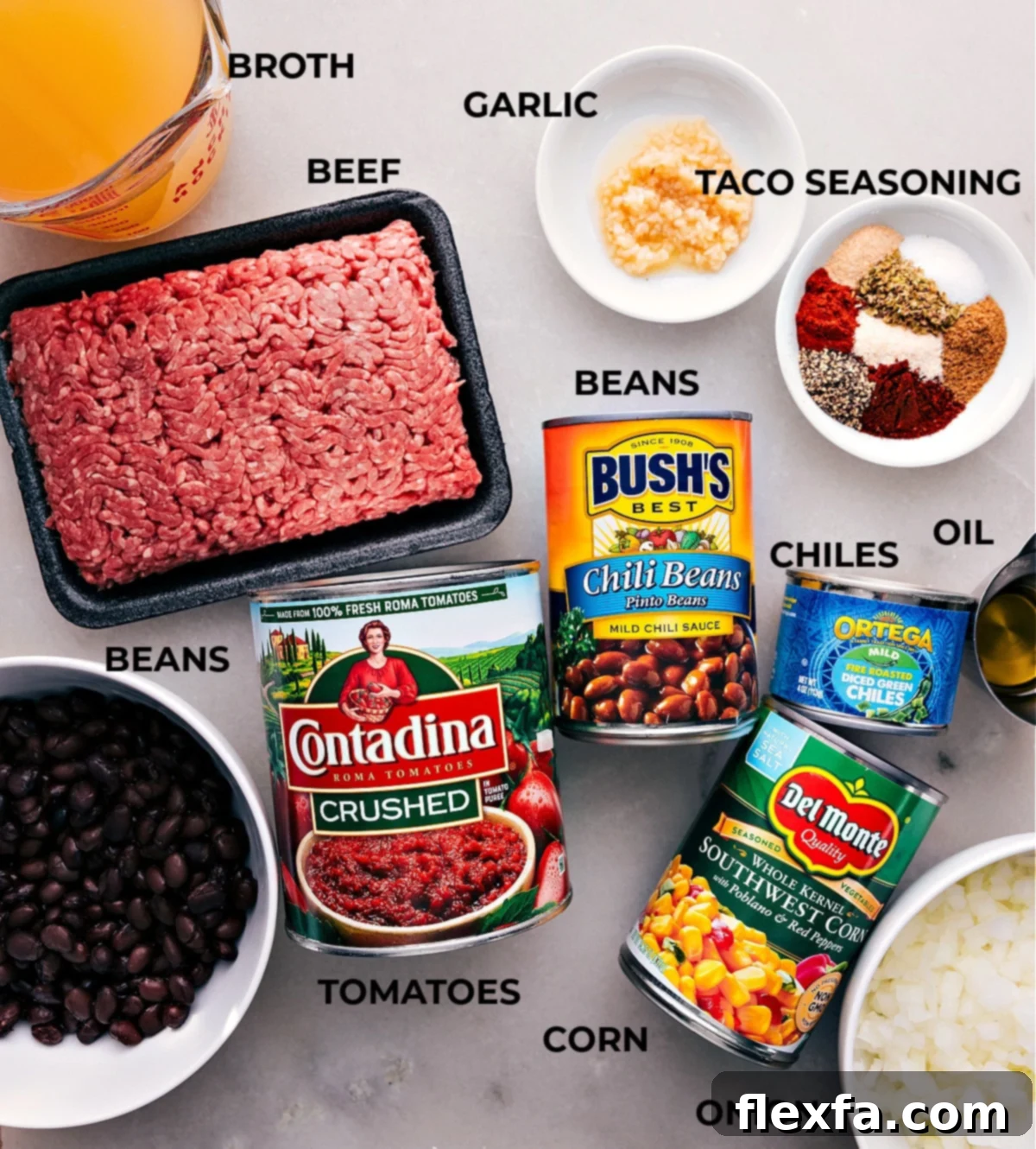 A vibrant display of all the essential ingredients for a delicious Taco Soup, including ground beef, various canned beans and corn, fresh onions, garlic, and a colorful array of spices.