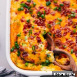 Mouthwatering Twice-Baked Potato Casserole in a casserole dish, ready to be enjoyed by someone.
