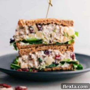 Stacked half-cut chicken salad with apples sandwich, showcasing the flavorful filling inside.