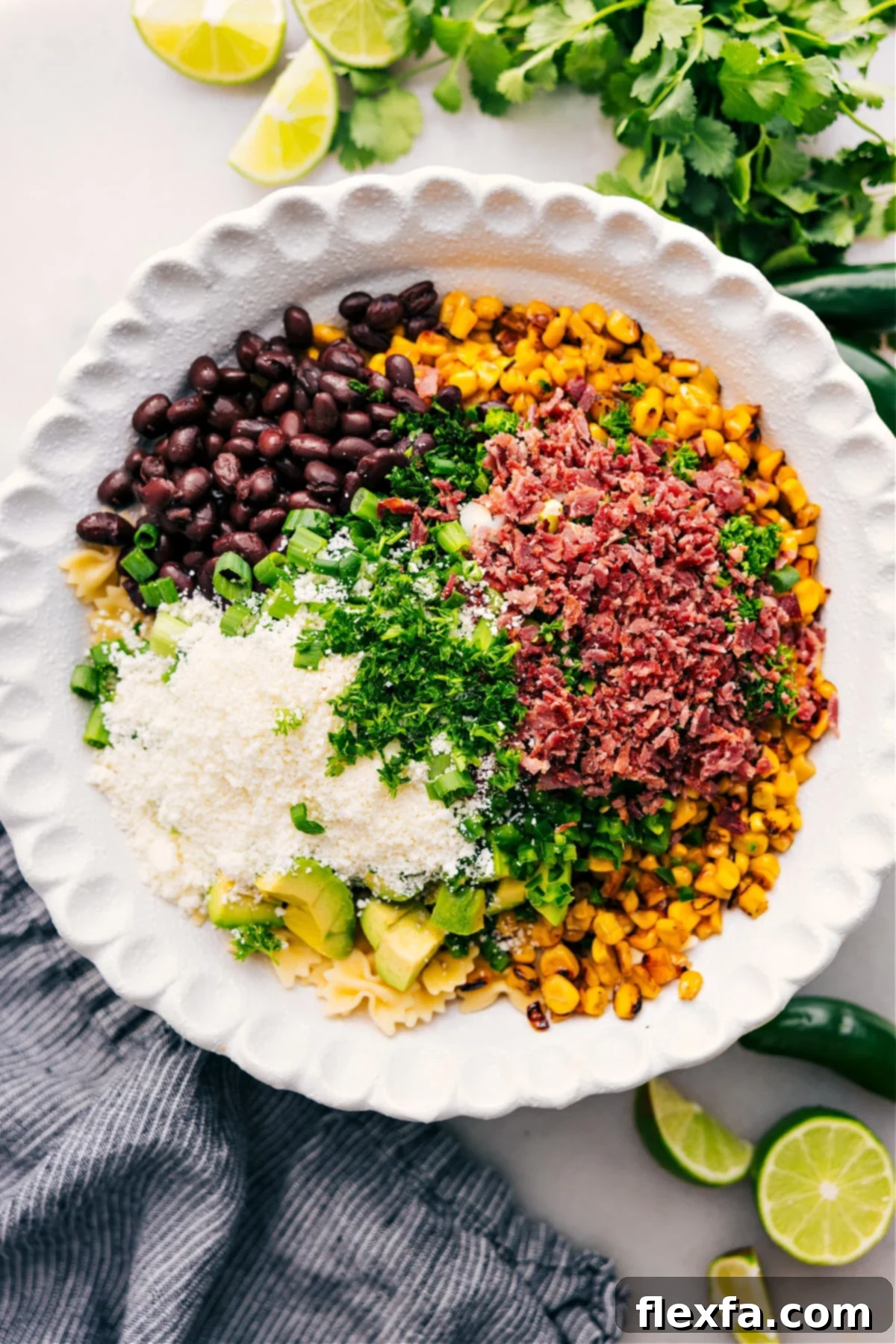 The Best Mexican Street Corn Pasta Salad Recipe Ever All the vibrant ingredients for Mexican Street Corn Pasta Salad, including cooled pasta, charred corn, avocado, black beans, herbs, and cheese, combined in a large bowl, ready to be tossed with the creamy dressing.