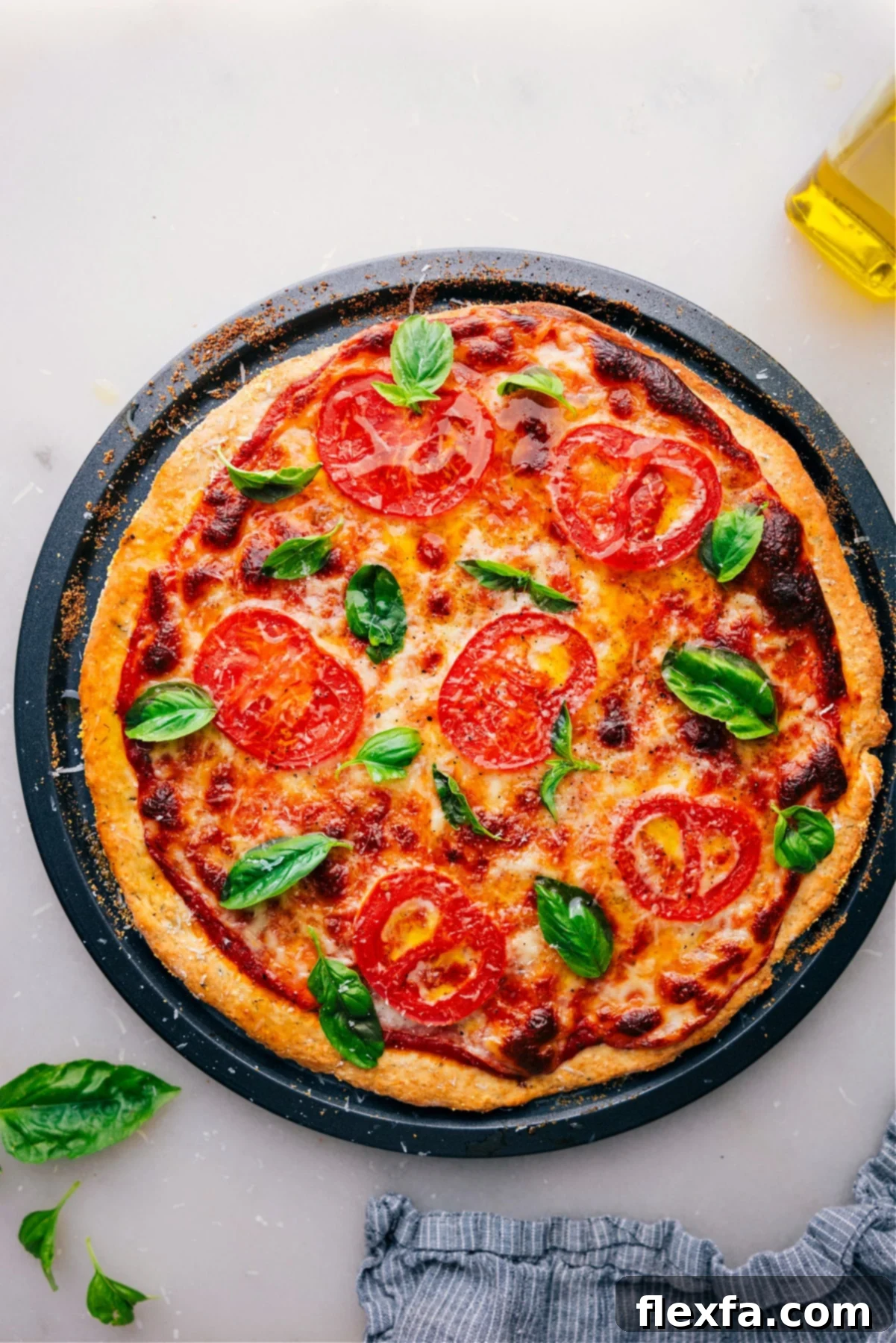 No-Yeast Pizza Dough pizza, freshly baked and straight out of the oven. A golden, crispy crust topped with melted cheese and fresh basil, ready to be enjoyed.