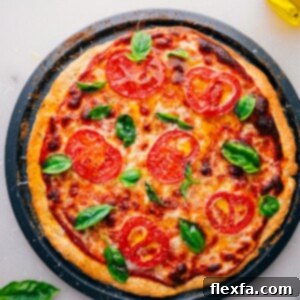 No-yeast pizza dough pizza, freshly baked and straight out of the oven. A close-up of a pizza slice showing a crispy crust and melted cheese.