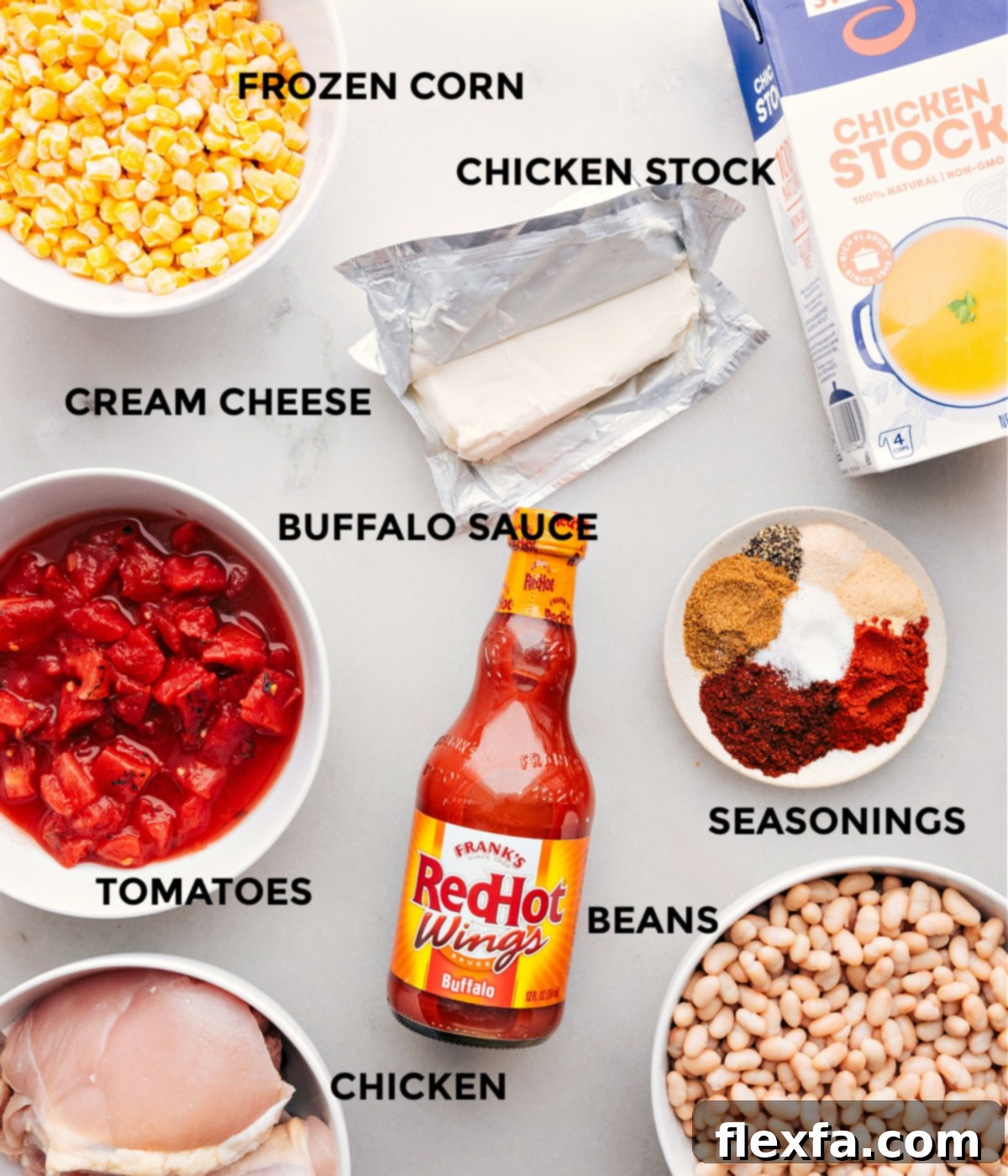 Delicious ingredients used in Buffalo Chicken Chili, including hot sauce, corn, beans, tomatoes, chicken stock, and chicken thighs, meticulously arranged and ready for the slow cooker.