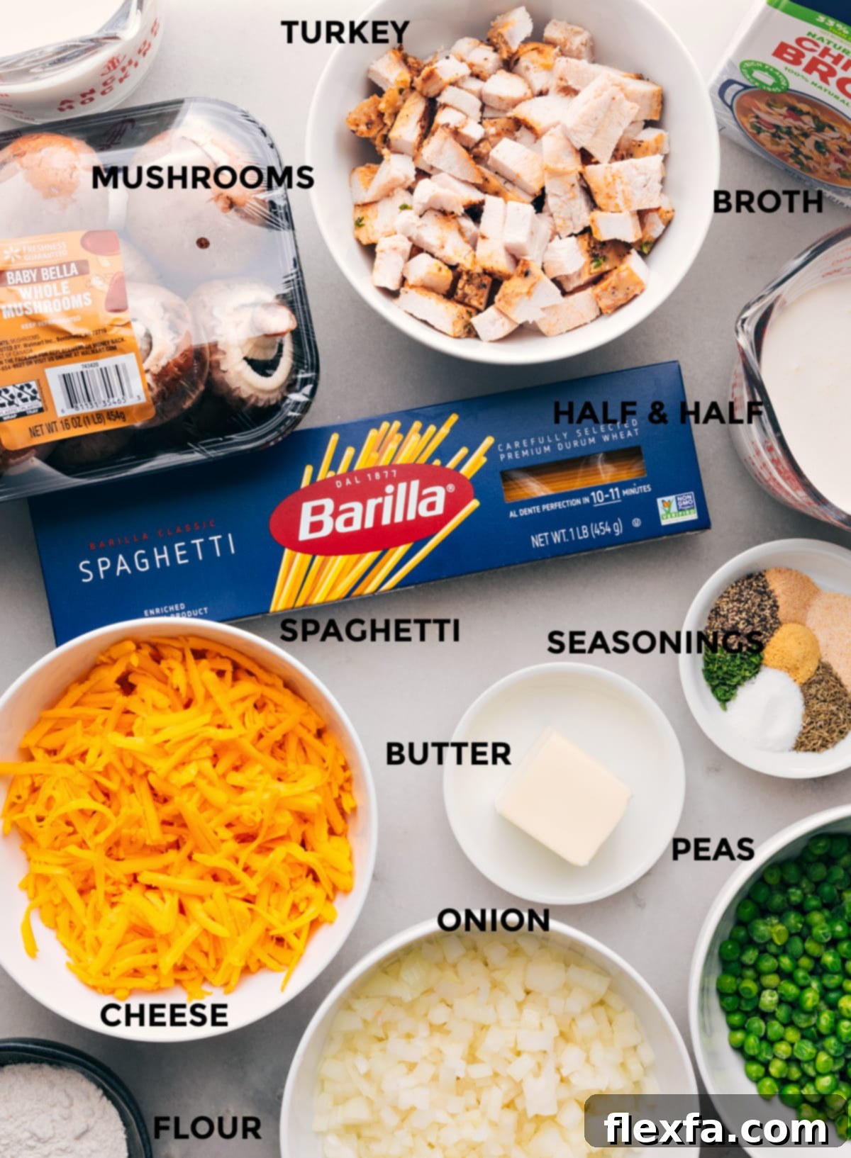 A collection of all the ingredients used in the recipe, including cheese, onion, peas, butter, noodles, and more.