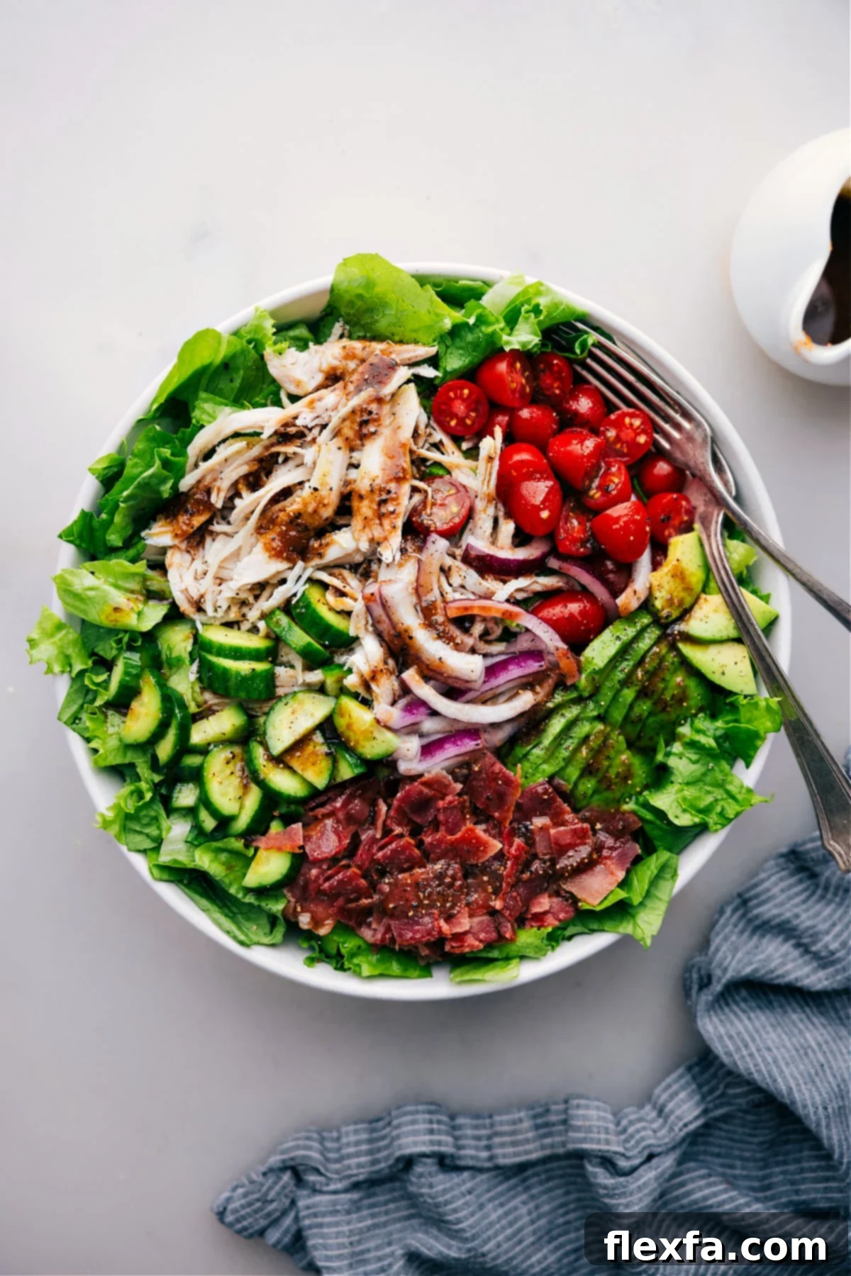 Big Bowl Of Turkey Bacon Avocado Salad A large, vibrant bowl of Turkey Bacon Avocado Salad, dressed and ready to be enjoyed, showcasing the colorful ingredients and rich texture.