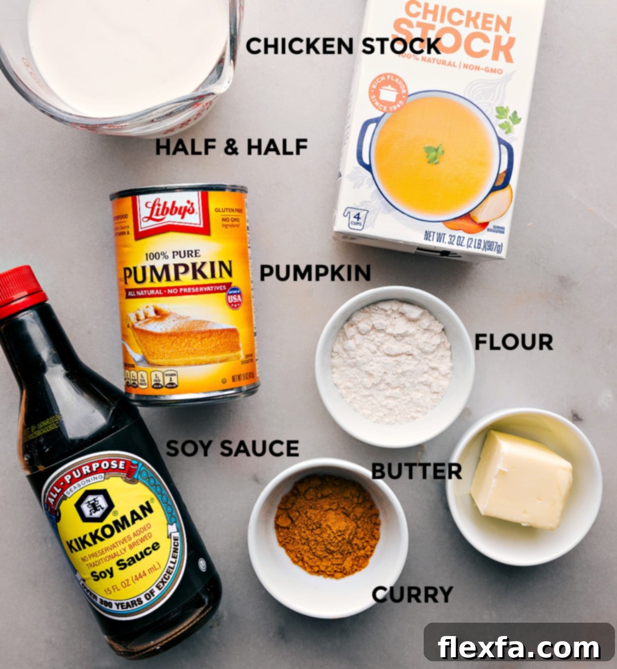 All the essential ingredients for making Pumpkin Curry Soup laid out for preparation.