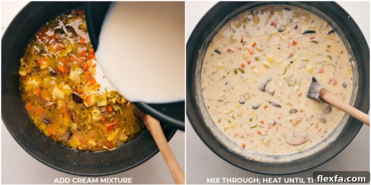 Heavy cream being slowly poured into a pot of rich, simmering vegetable and artichoke soup, creating a swirl of creamy texture as it thickens to perfection.