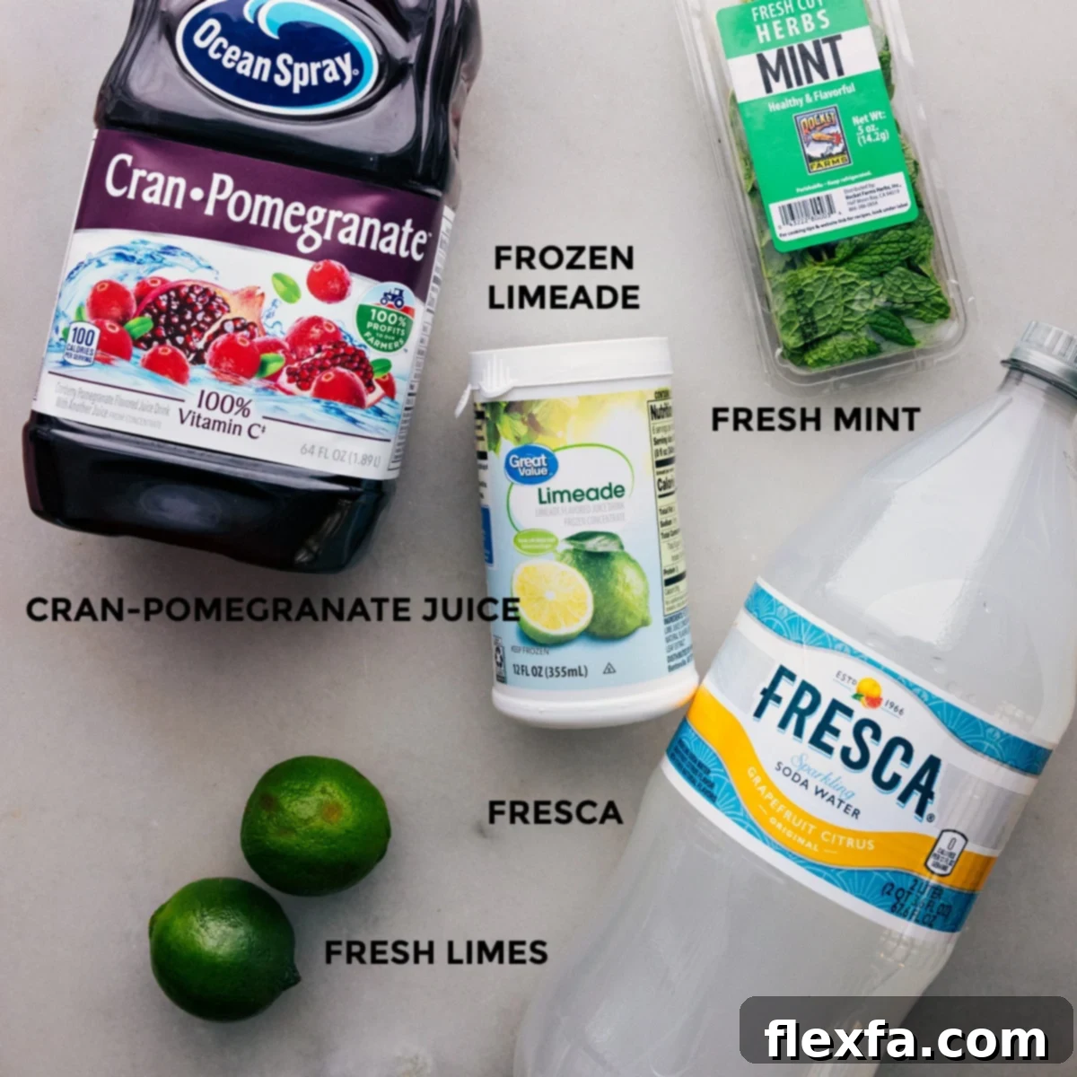 All the vibrant ingredients for the Christmas punch, including bottles of juice and soda, fresh limes, and pomegranates, neatly arranged on a table, showcasing their freshness and quality.