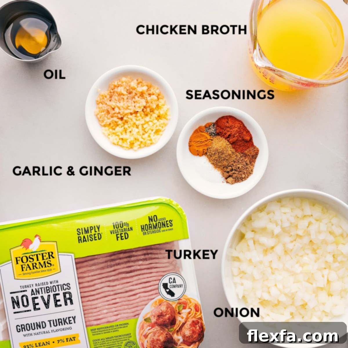An inviting spread of fresh ingredients laid out on a clean kitchen counter, showcasing vibrant yellow onion, meticulously minced fresh garlic and ginger, lean ground turkey, a colorful assortment of Indian spices in small bowls, chicken broth, and a portion of frozen peas, all prepped and ready for cooking these delightful Indian Ground Turkey Bowls.