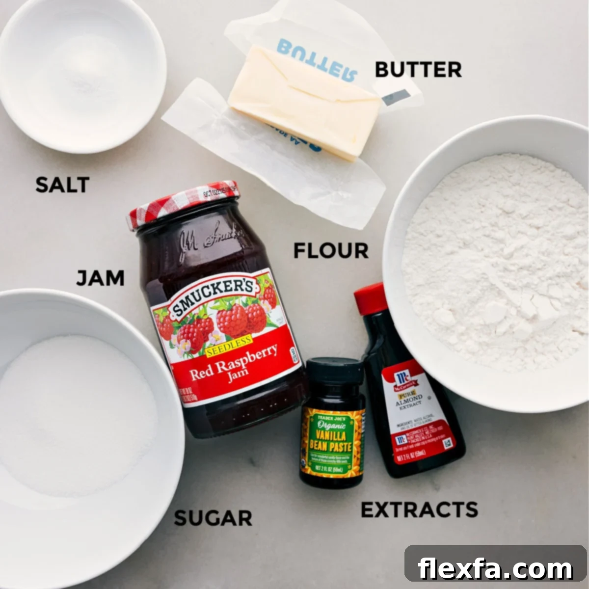 Ingredients for Costco Raspberry Crumble Cookies, prepped and laid out on a clean surface, including butter, sugar, flour, and a jar of raspberry jam.